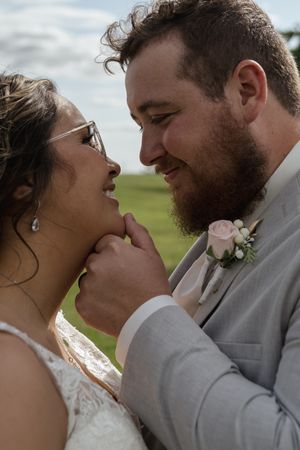 Intimate wedding portrait sequence captured against natural outdoor backdrop.