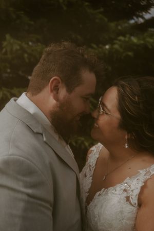 Romantic wedding couple portrait series in moody lighting outdoors.
