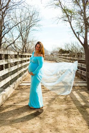 A sequence of photos shows a person in a turquoise dress twirling with a flowing white veil on a wooden boardwalk.