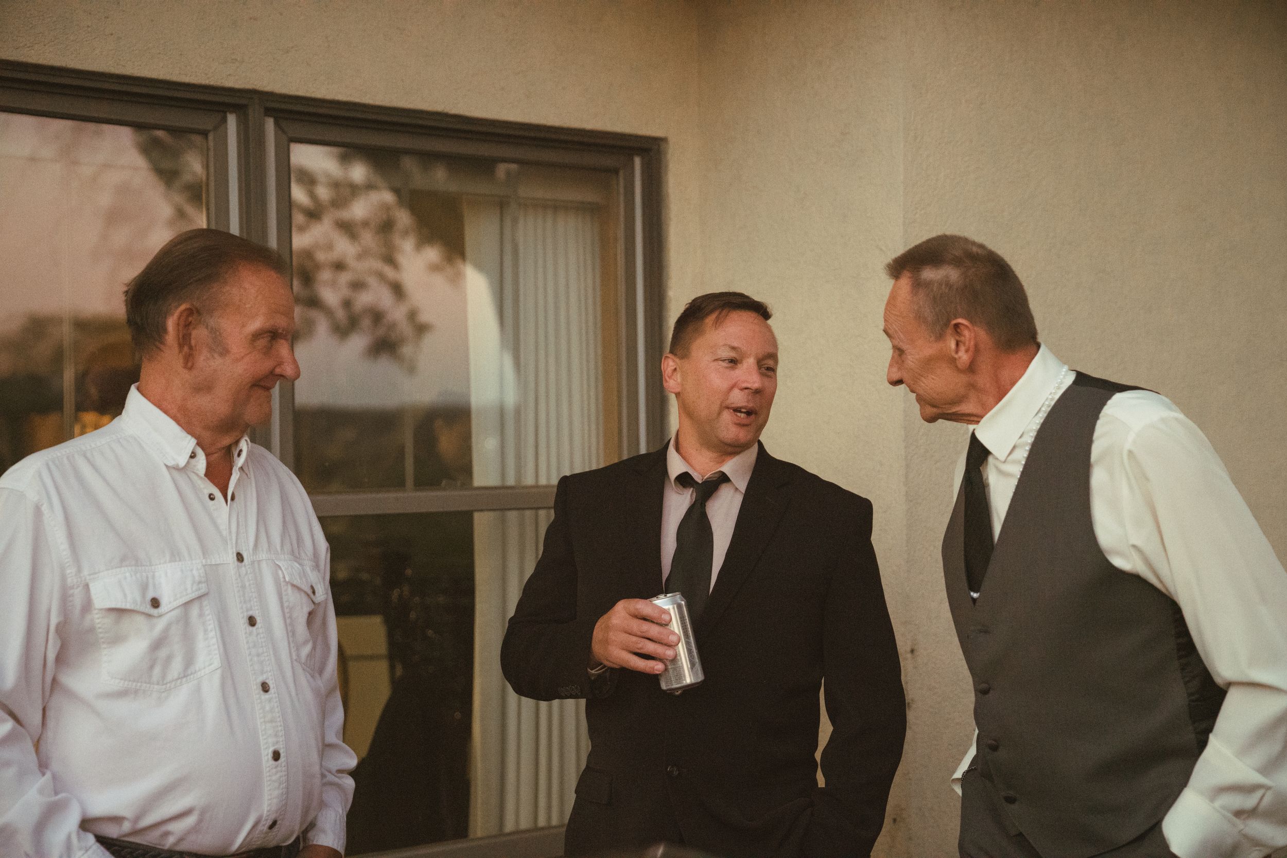 Wedding guests mingling and socializing at an indoor reception venue.