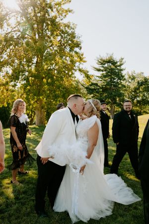 Wedding celebration captured in candid moments on a sunny hillside.