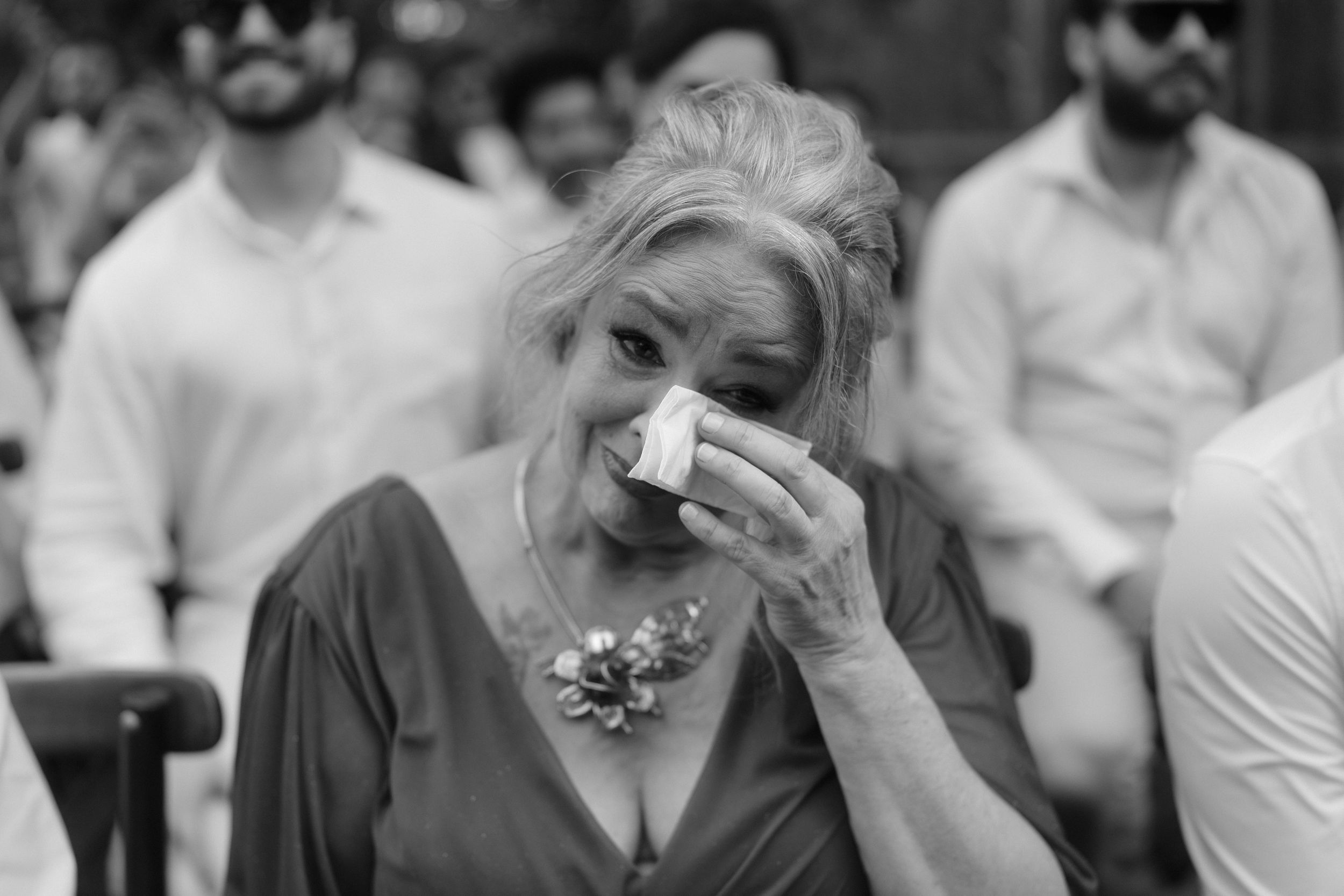 An emotional black and white moment captured during a wedding ceremony.