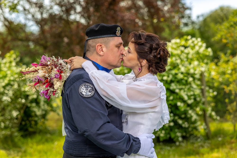 A romantic wedding photo session in a beautiful spring garden setting with white flowers and greenery.