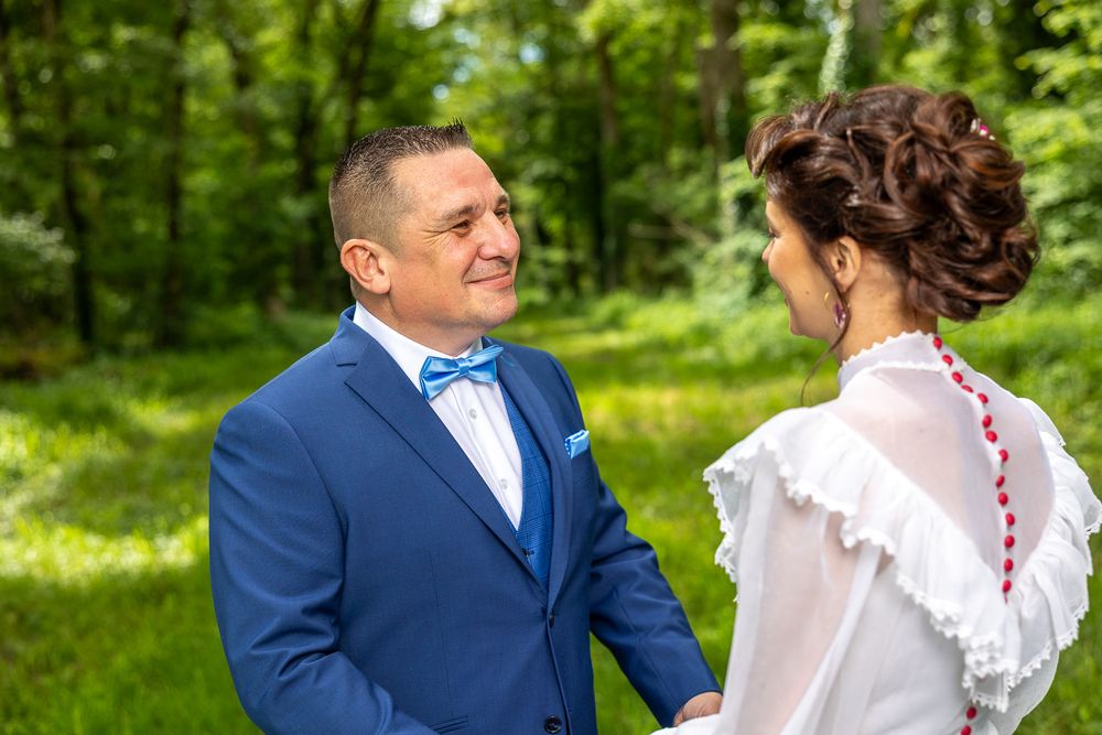 Wedding portraits taken in a natural garden setting with vibrant greenery.