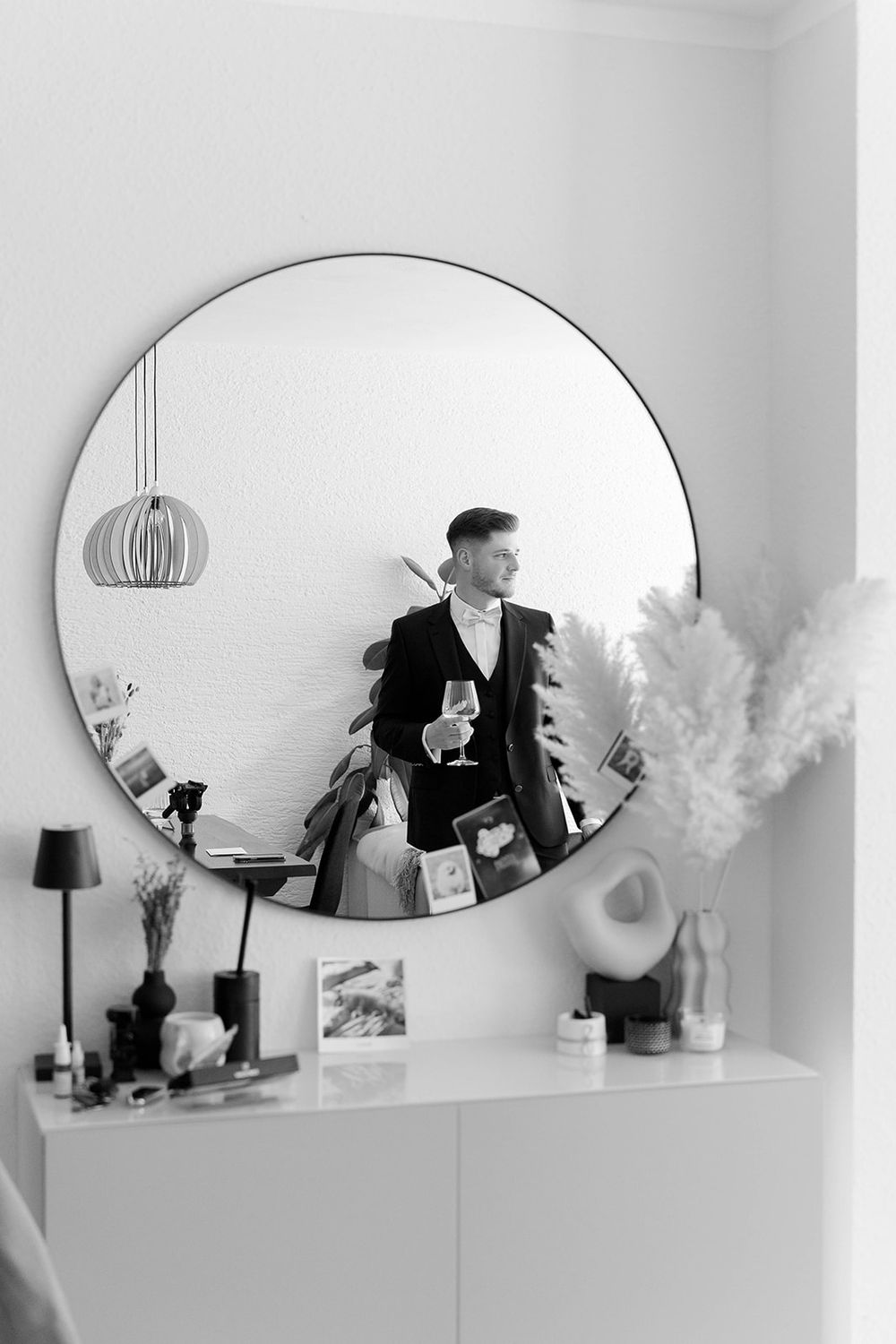 Modern interior with oval mirrors and decorative items on a white shelf.