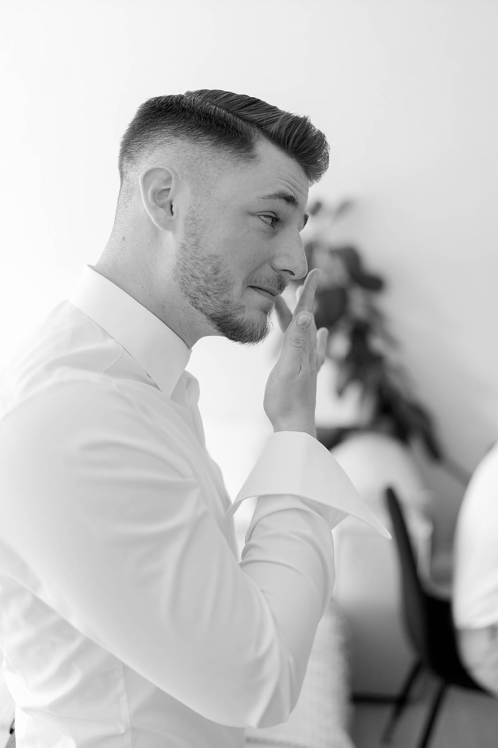 Person in white shirt reading an emotional letter or note.