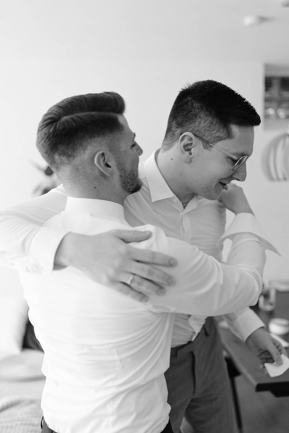 Two people in formal attire sharing an emotional embrace.