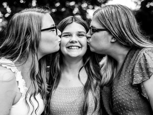 Black and white portrait series capturing intimate joyful moments and laughter.