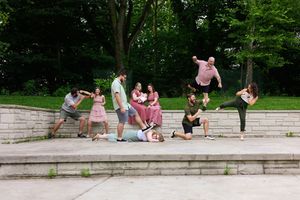 Group seated on concrete steps during outdoor photo session.