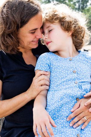 Two people share tender moments of affection in a series of casual outdoor portraits.