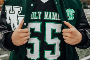 Green and white sports jerseys with number displays team pride.