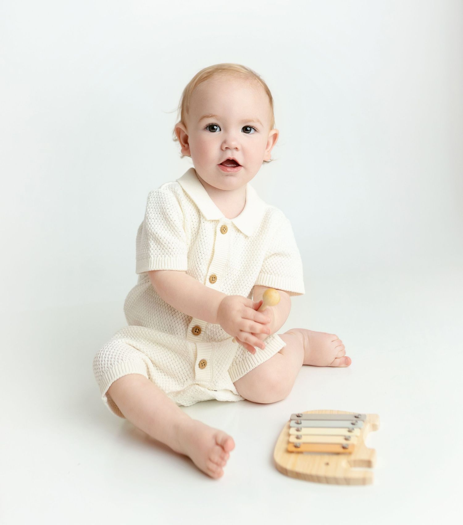 A little boy looking at the camera with a grin. Greenville SC milestone Photographer, Easley, SC newborn photographer