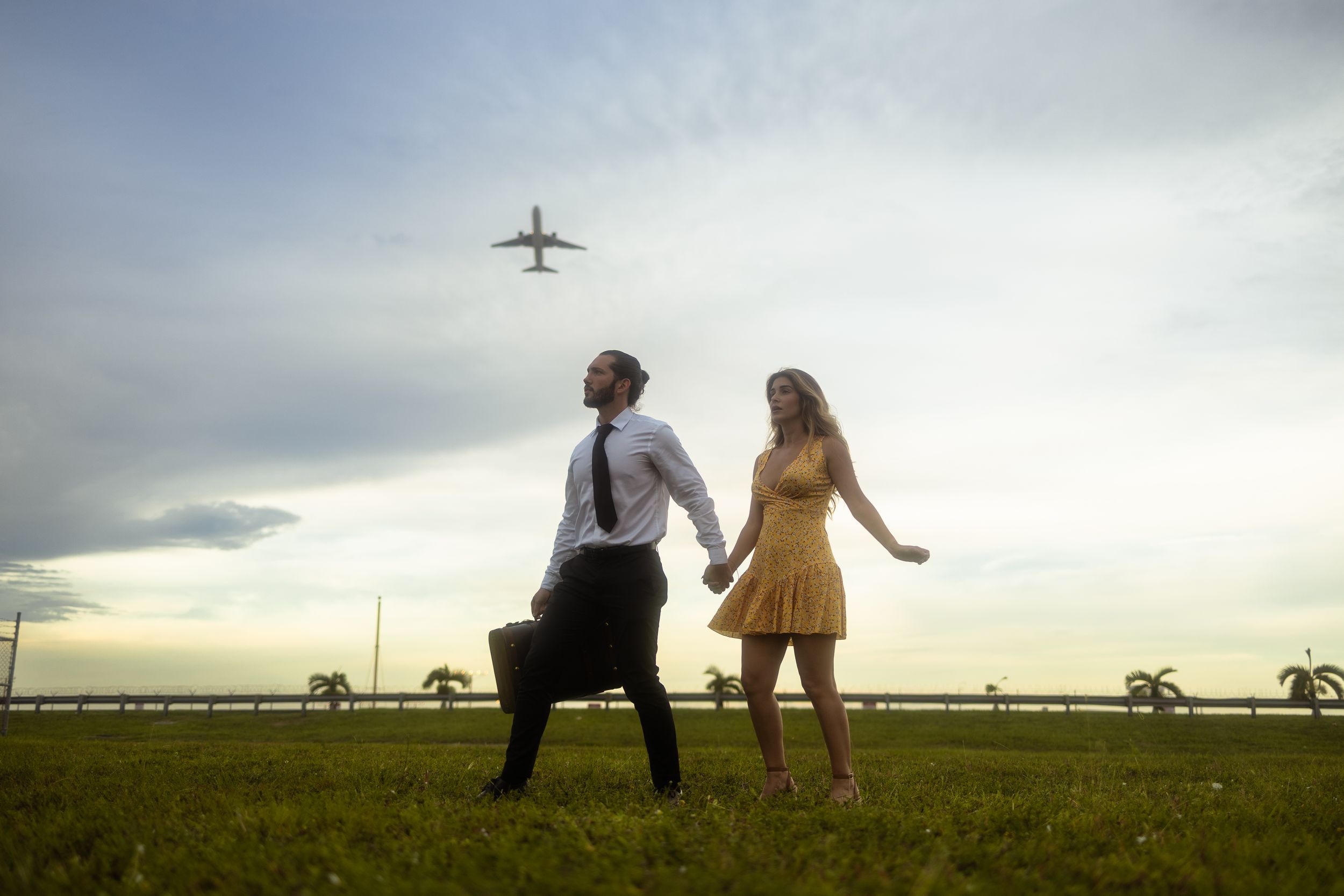 Romantic Miami engagement portrait under plane, cinematic proposal photography perfect for Pinterest couples by MannyPortraits.