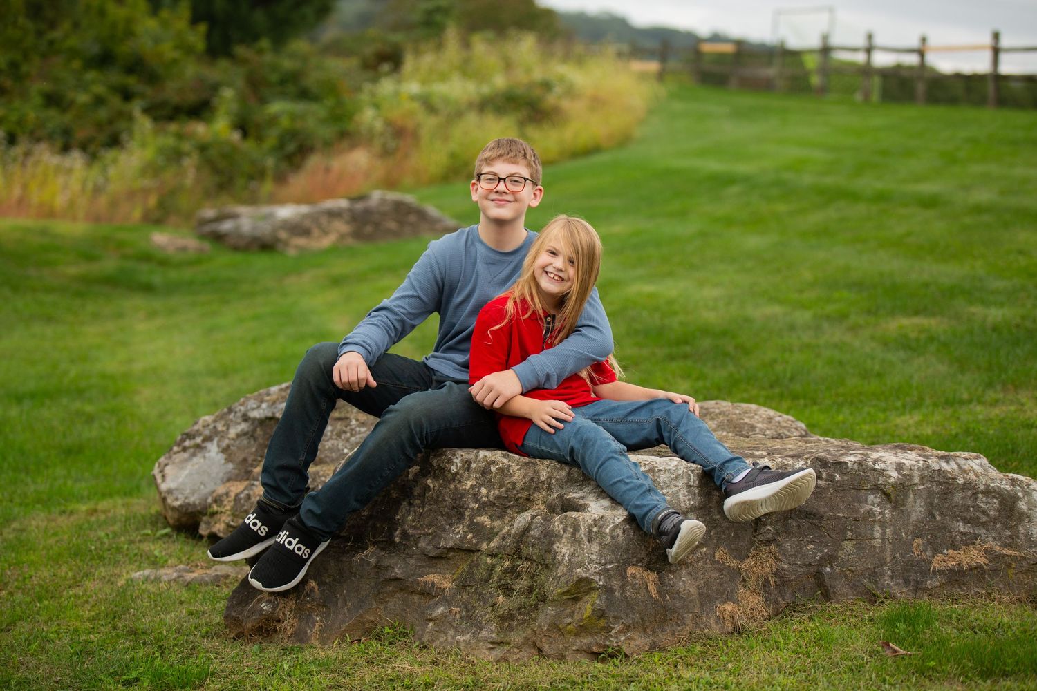 Casual outdoor portraits on rocky terrain with natural landscape backdrop.