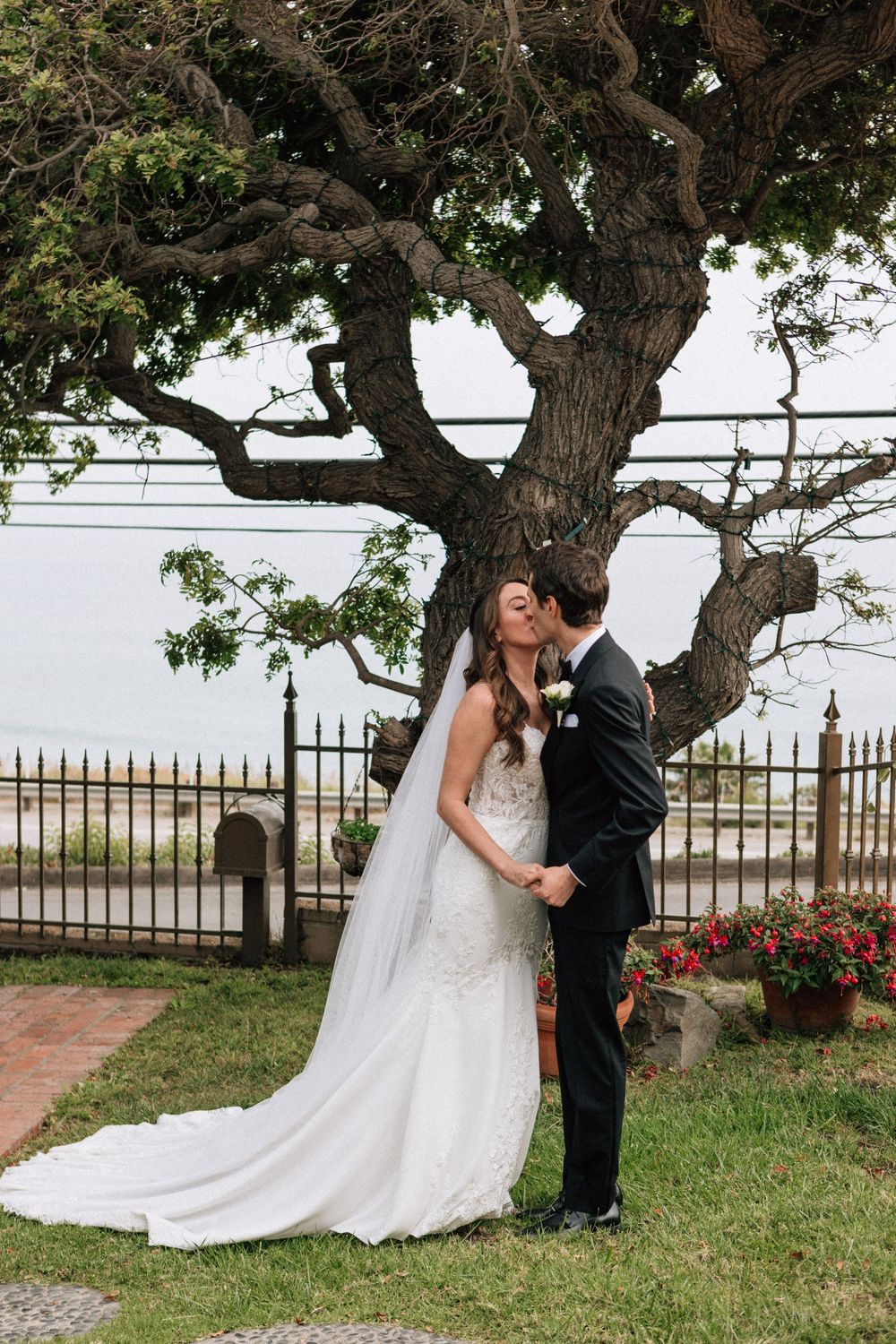 The first kiss at a Malibu beach elopement captured by a film photographer.