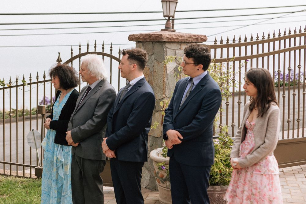 Family watching an intimate Malibu wedding ceremony at a private PCH residence.