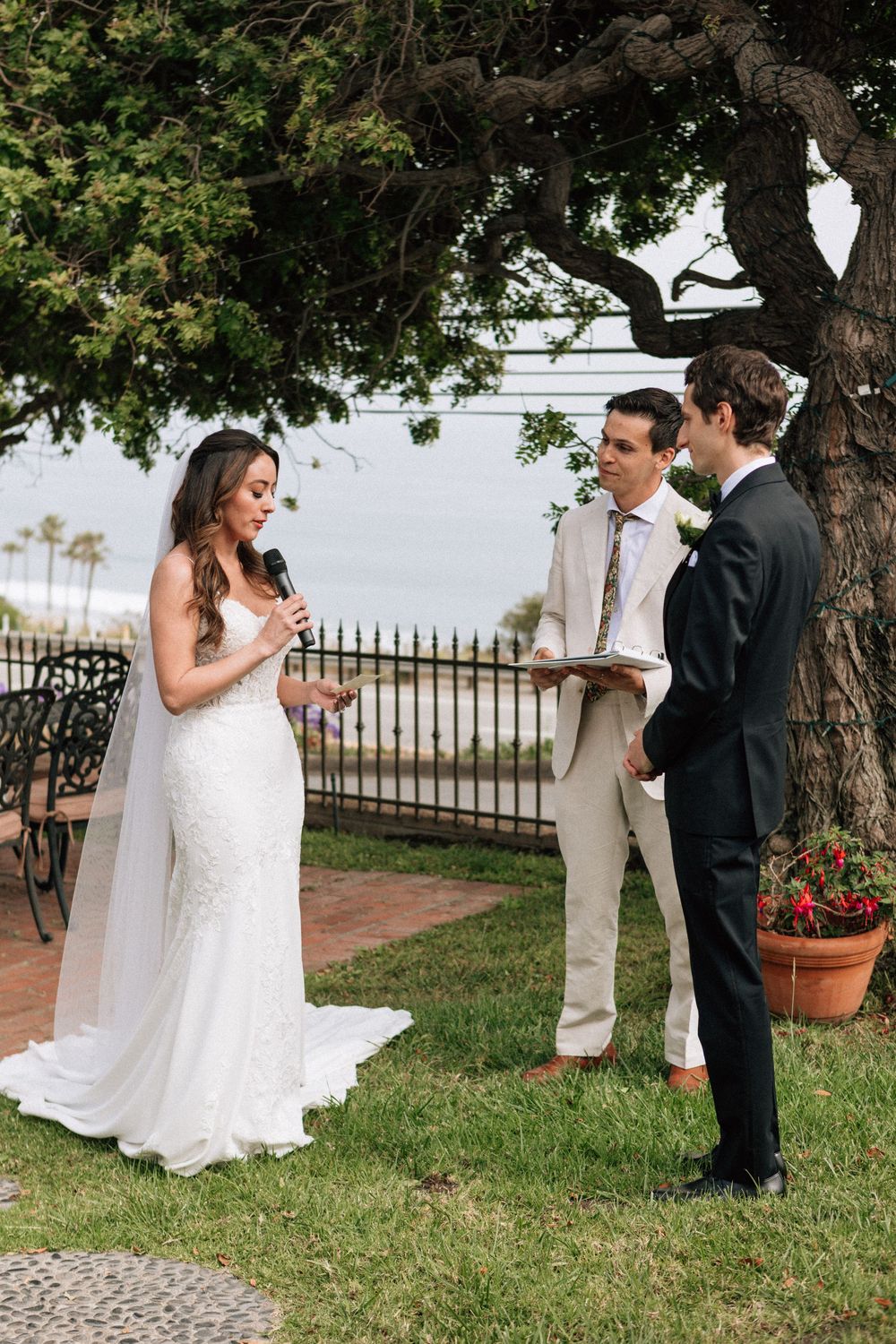 Malibu film photographer capturing private wedding vows under a coastal oak tree.