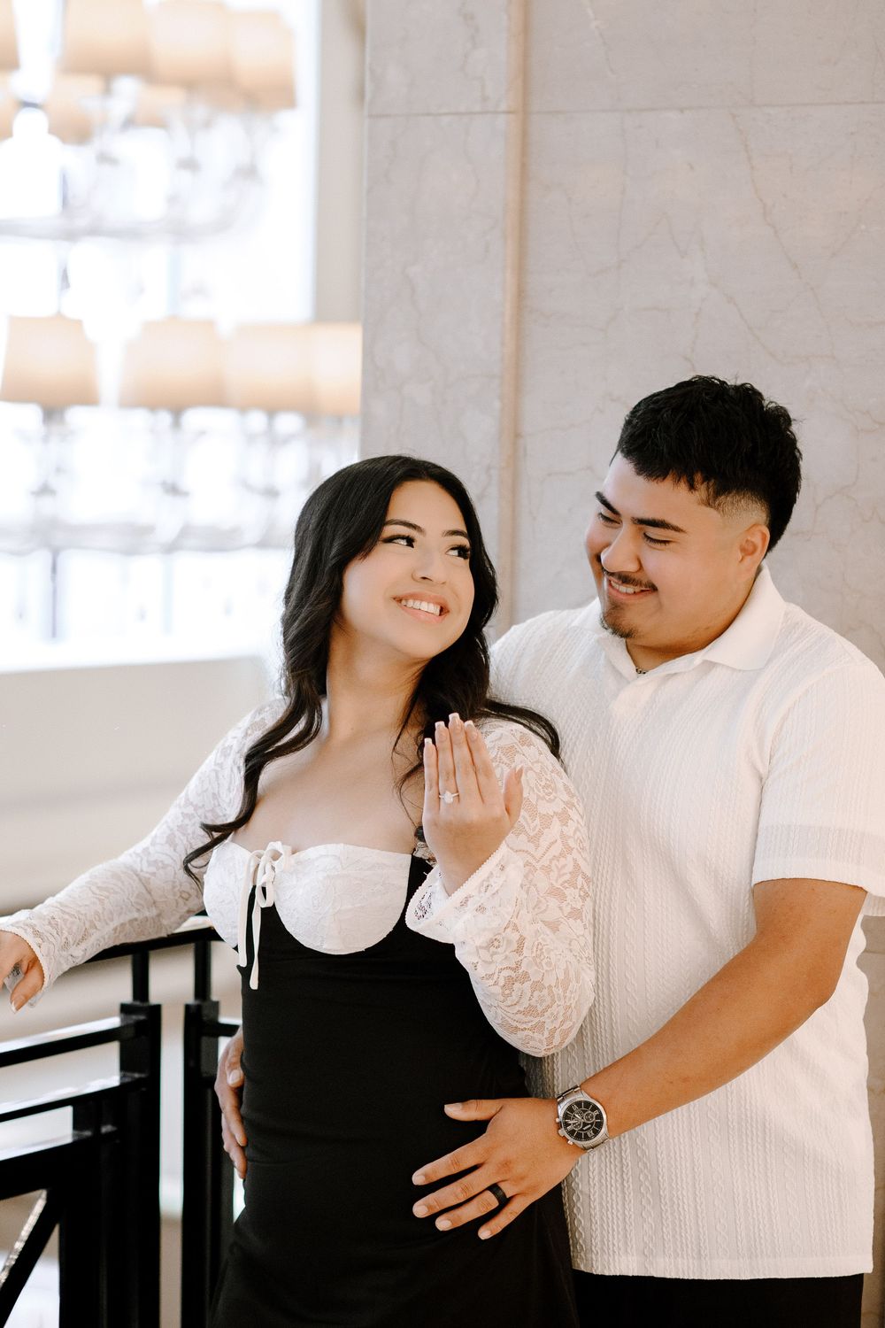 A loving couple shares intimate moments in a bright white room, embracing and smiling in four candid photo frames.