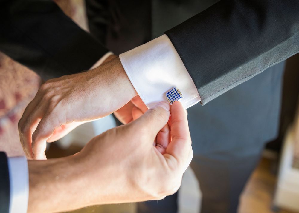 Close-up shots of hands exchanging wedding rings during the ceremony.