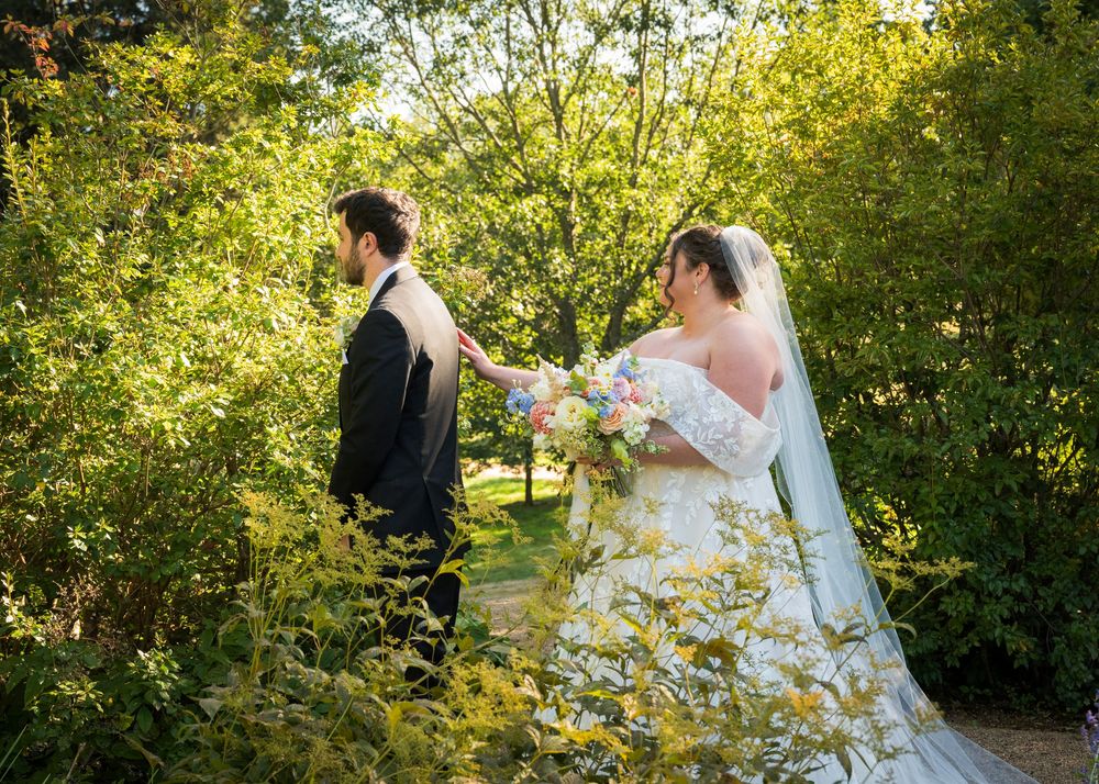 Wedding couple portraits taken in a lush garden setting with golden sunlight filtering through.