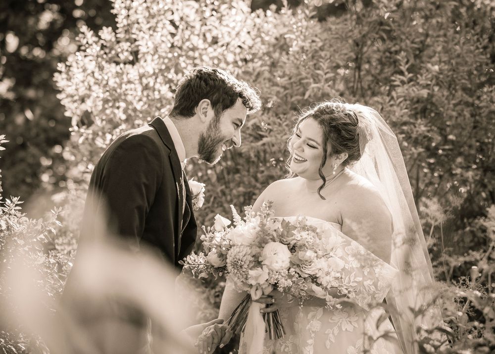 Romantic sepia-toned wedding ceremony shots captured through blossoming tree branches.