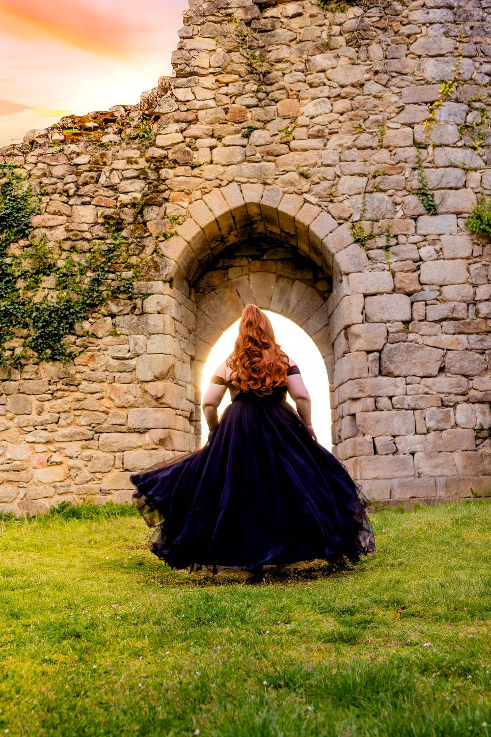 Princesse qui court avec une longue robe et un coucher de soleil, vers un château