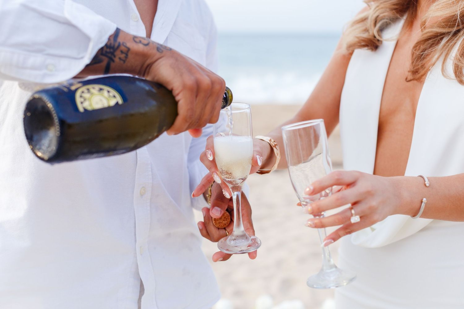 Couples portrait on the beach. Marriage proposal. Opening champagne. San Juan, Puerto Rico.