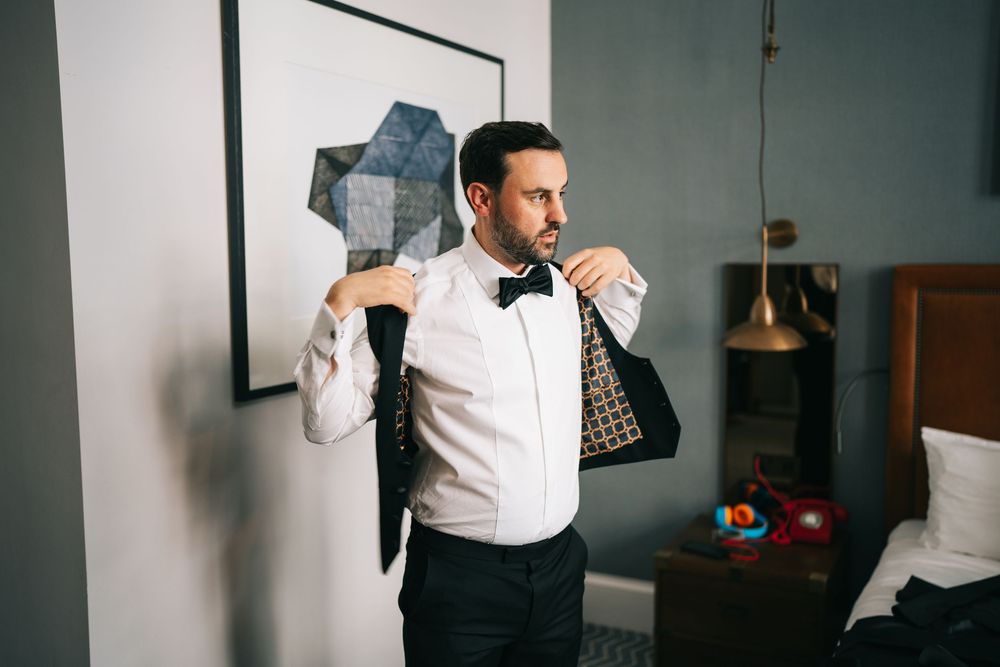 Professional wearing a white shirt works in a modern office while holding a digital tablet.