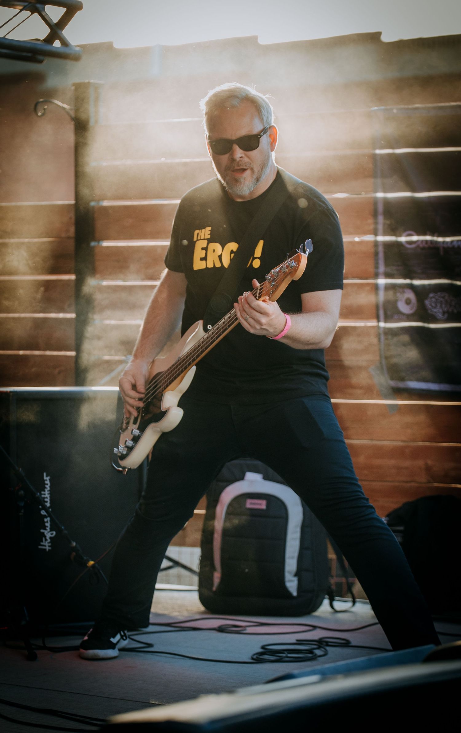 Series of cropped photos showing a guitarist playing electric guitar in a dimly lit studio setting.