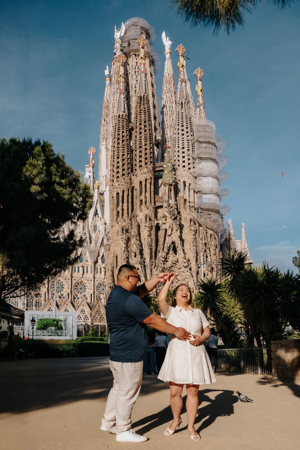 Romantic honeymoon portrait with Sagrada Familia columns in the background.
