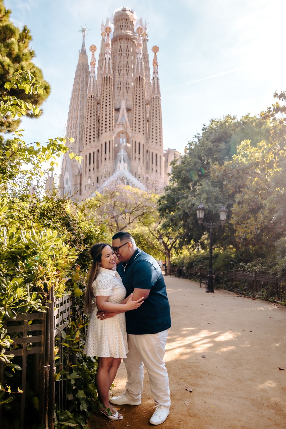 Couple laughing together as sunlight filters through the stained glass windows.