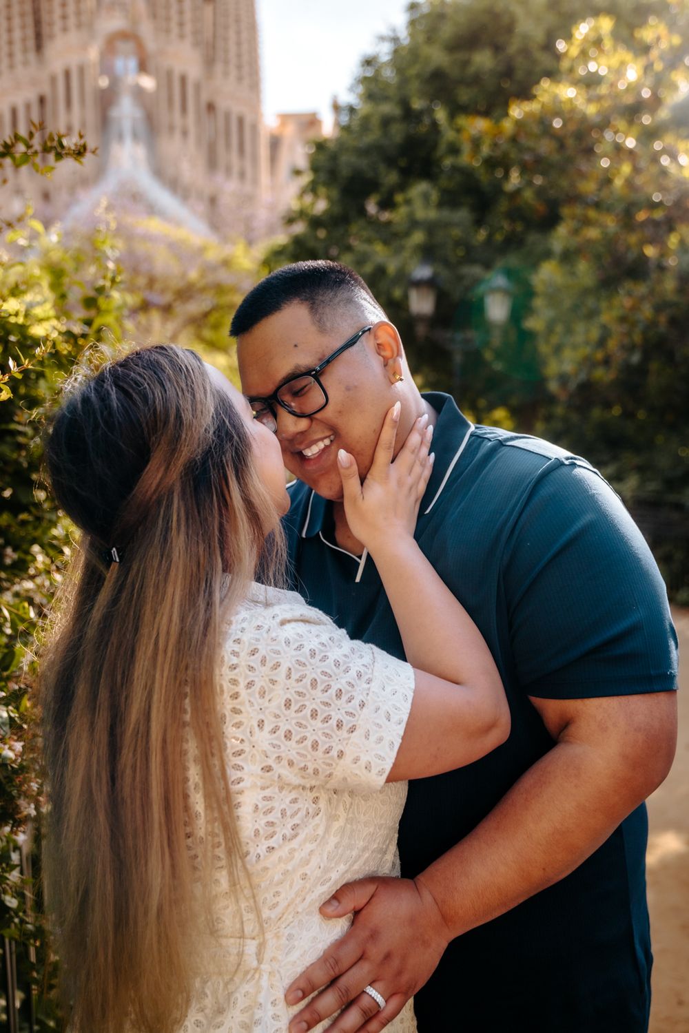 Tender forehead touch captured during the honeymoon session in Sagrada Familia.