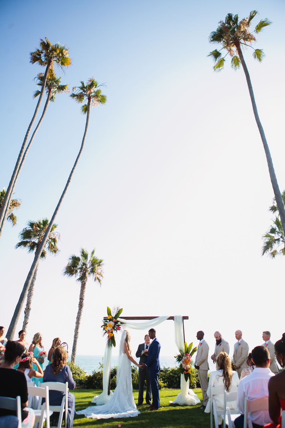 Bride and groom during wedding ceremony overlooking the ocean at Ole Hanson Beach Club in San Clemente, California.