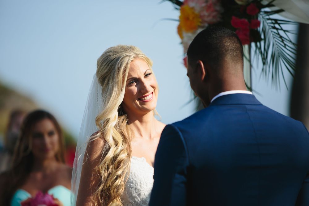 A couple shares an intimate moment during their wedding ceremony at Ole Hanson Beach Club in San Clemente, California.