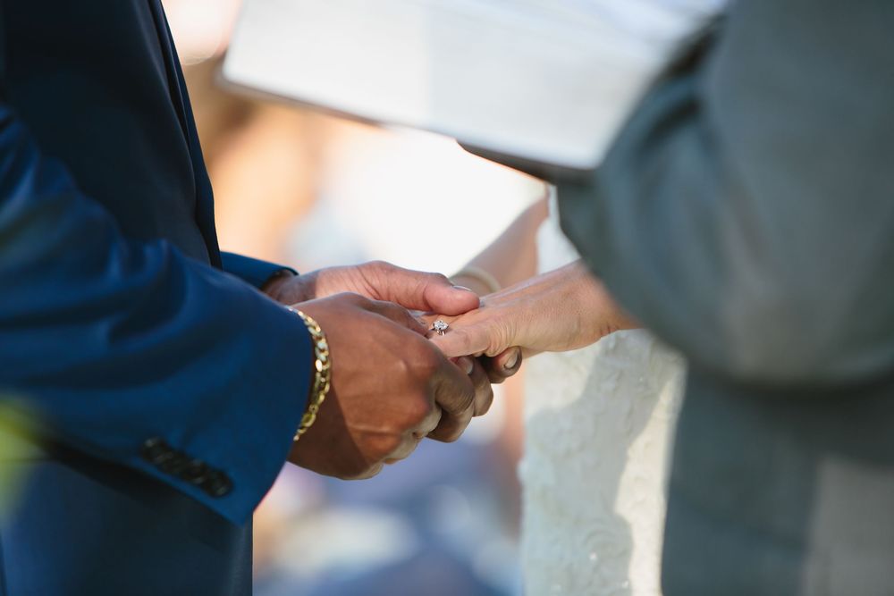Wedding ceremony vows with couple holding hands.