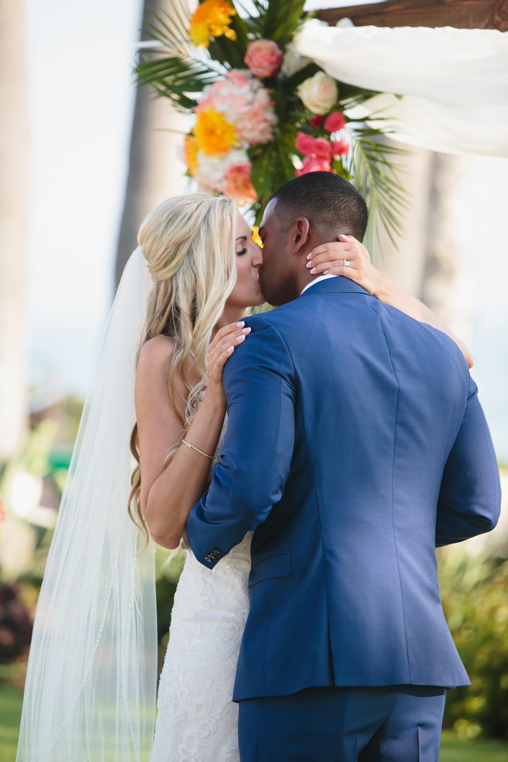 First wedding kiss at Ole Hanson Beach Club in San Clemente during wedding ceremony overlooking the ocean.
