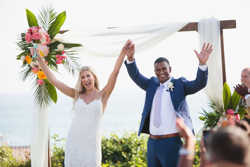 Bride and groom celebrate at Ole Hanson Beach Club in San Clemente during wedding ceremony.