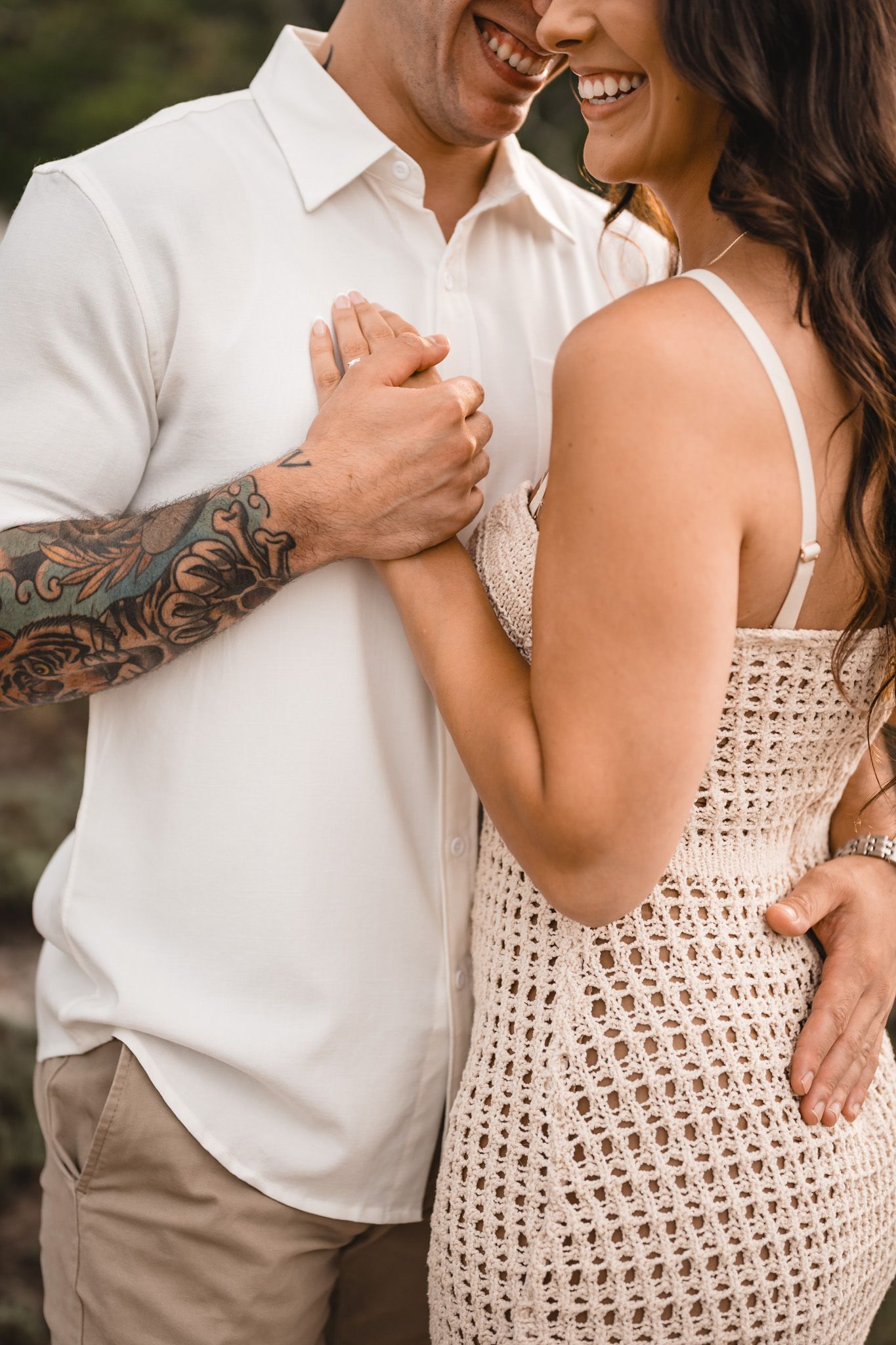Close-up shots of a couple in coordinated beige and white outfits showing affectionate moments.