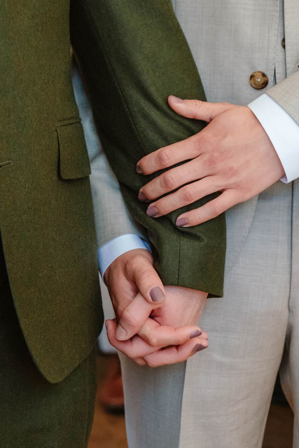 Coombe Lodge Somerset Wedding Photographer Zara Davis Photography two grooms holding hands during ceremony