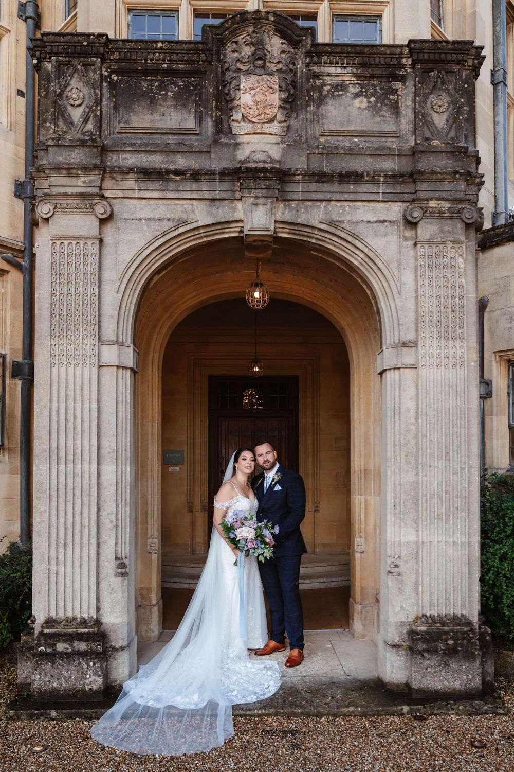 Coombe Lodge Somerset Wedding Photographer Zara Davis Photography bride and groom posed at entrance arch