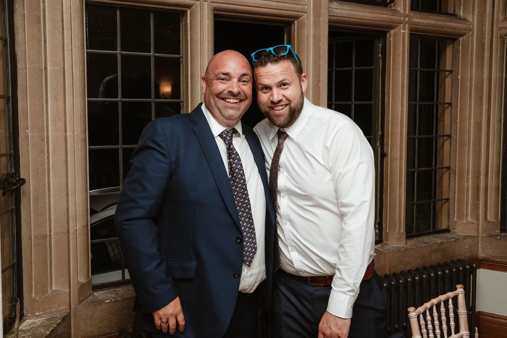Coombe Lodge Somerset Wedding Photographer Zara Davis Photography two guests during evening reception music room
