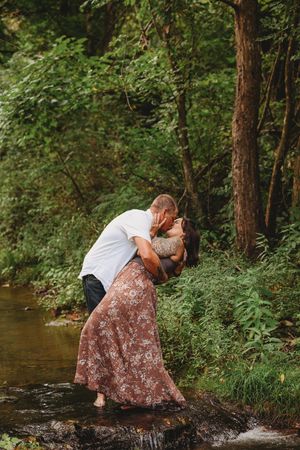 Candid moments captured of people exploring a wooded creek area.