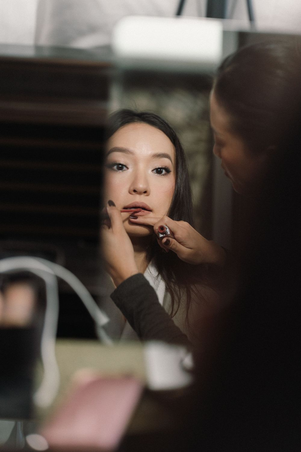 Close-up sequence showing makeup application on someone's lips during wedding preparations.