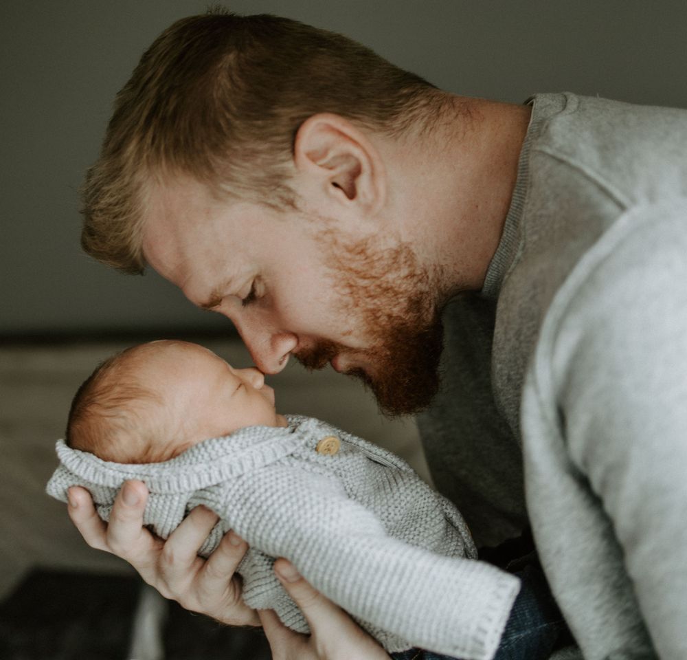 Tender moments between parent and baby captured in intimate close-up shots.