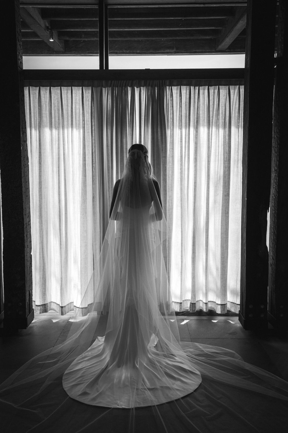 A series of black and white photos showing flowing sheer curtains silhouetted in front of bright windows.