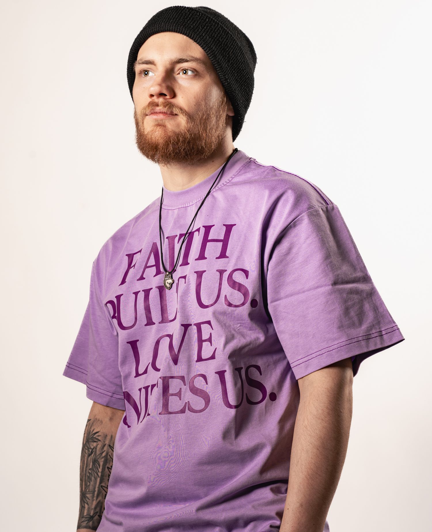 Purple t-shirt with faith-themed text design shown on model.