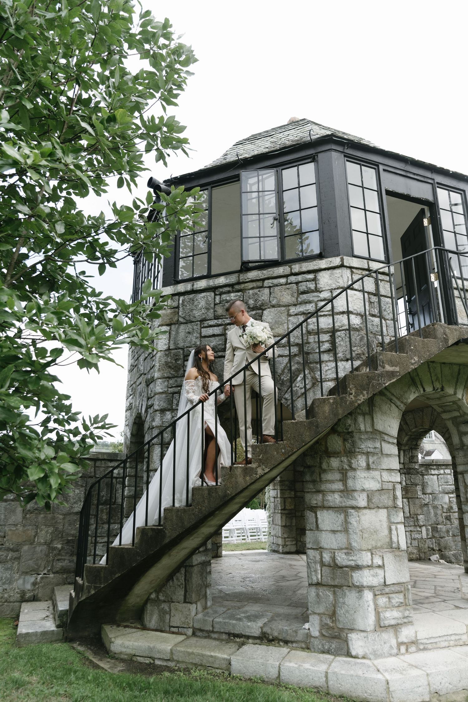 A sequence of photos showing a stone staircase with black railings leading to a glass-enclosed entrance of a historic building.