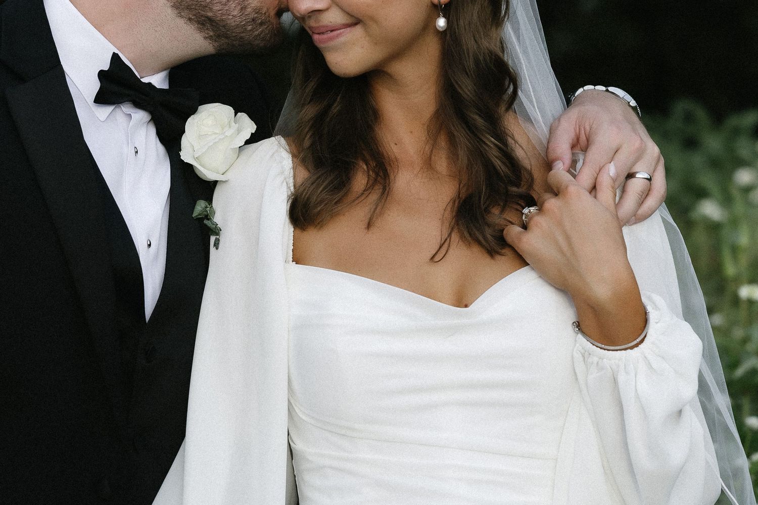 A couple in wedding attire share romantic moments in a series of black and white photographs outdoors.