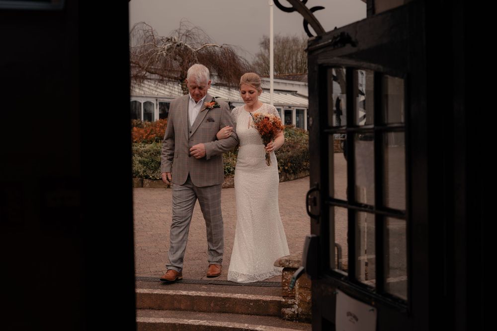 bride and her father walk to ceremony at Gretna Green in the Scottish Borders