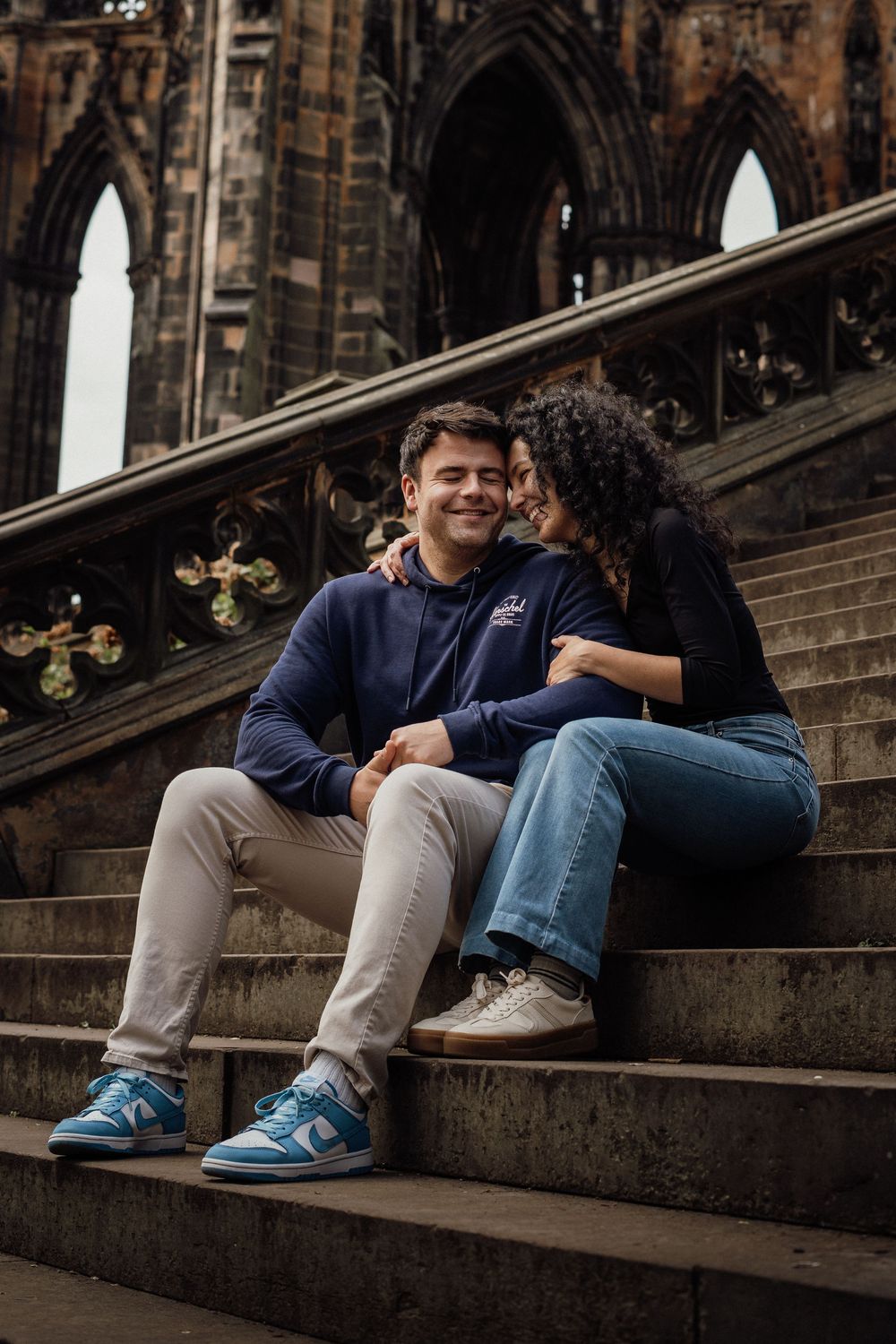 Candid engagement session with couple laughing together in Edinburgh  taken by Perthshire Photographer